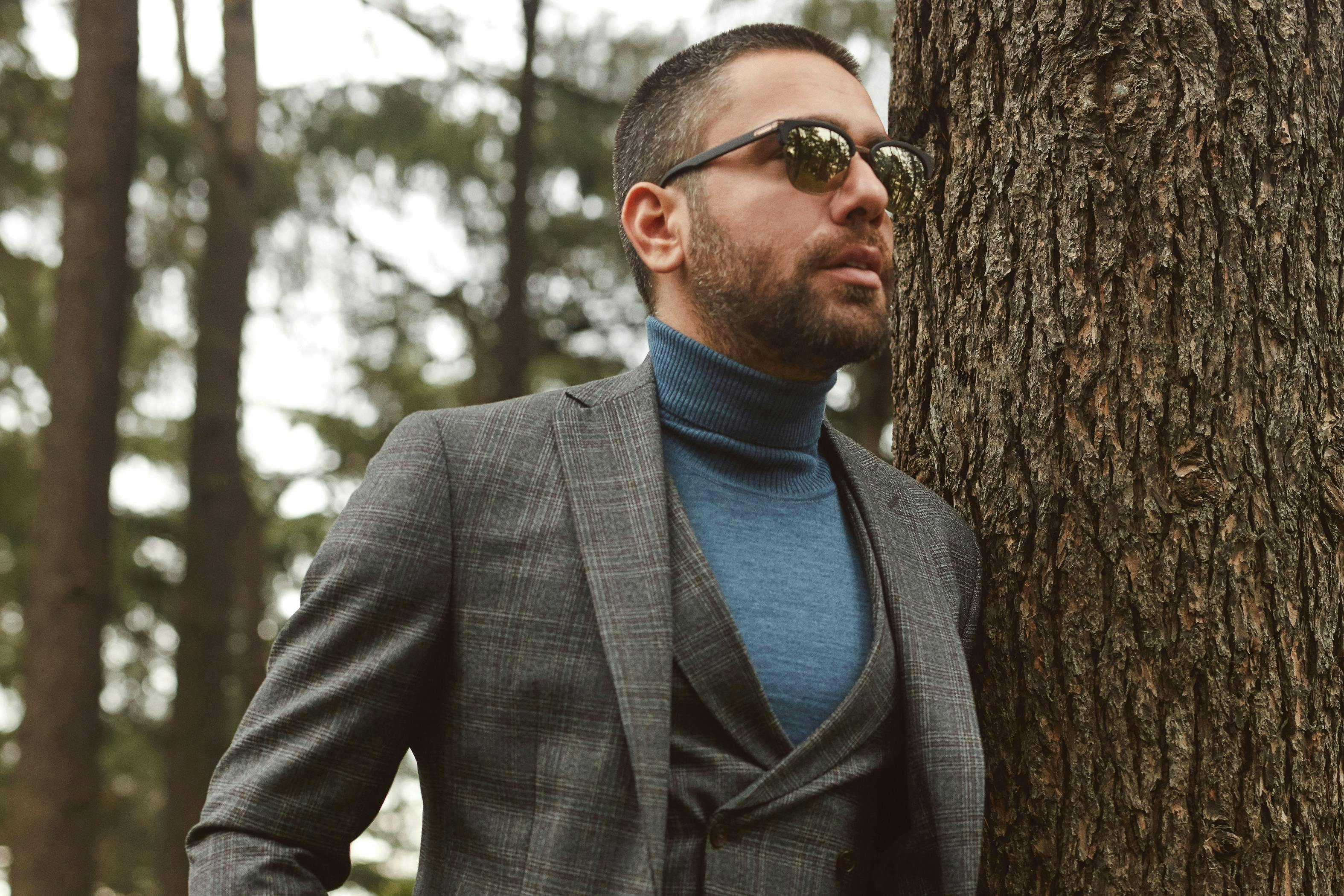 clothing person suit overcoat coat sunglasses accessories man tree plant