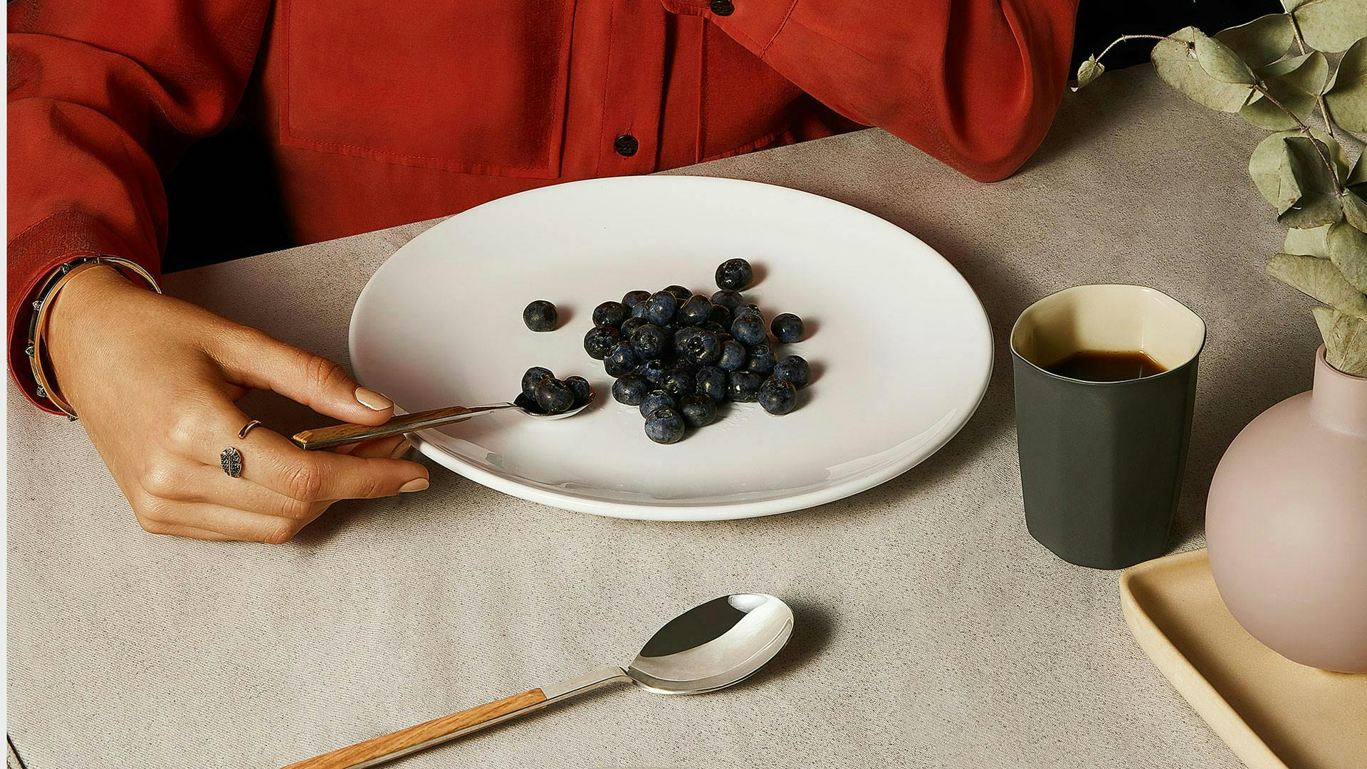 plant spoon cutlery person human blueberry food fruit coffee cup cup