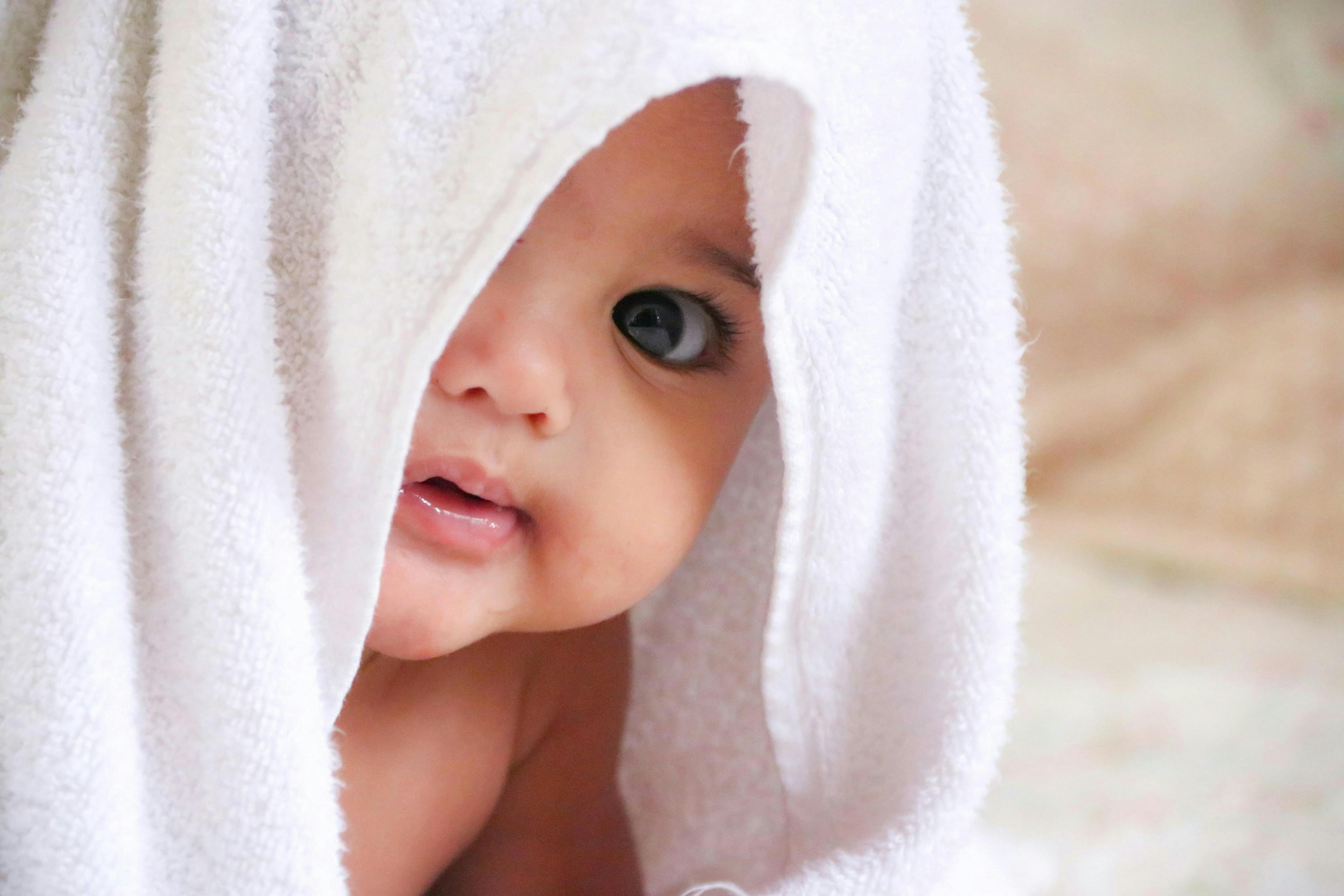 person human face newborn baby towel head